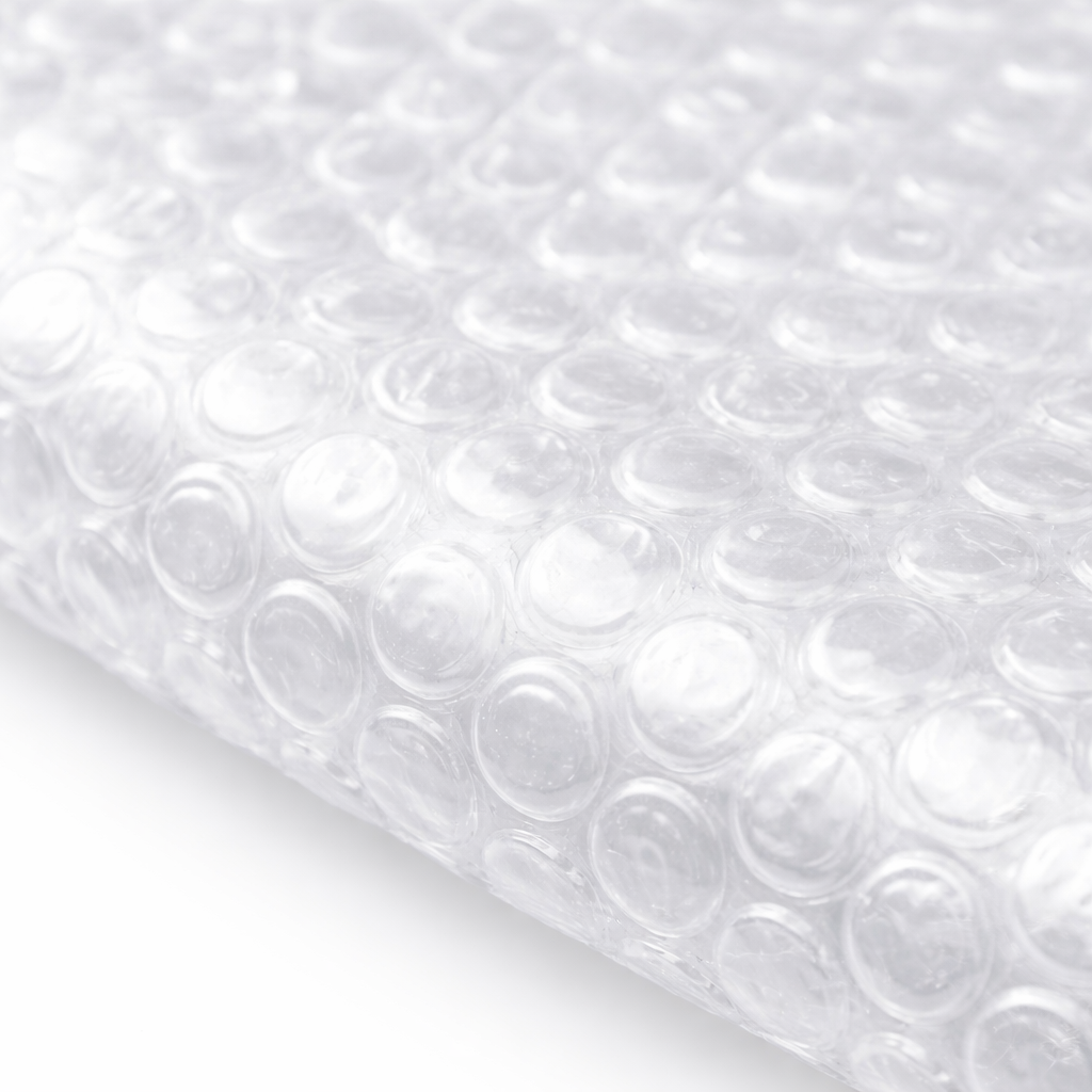Sheet of clear bubble wrap with circular air pockets on a white background