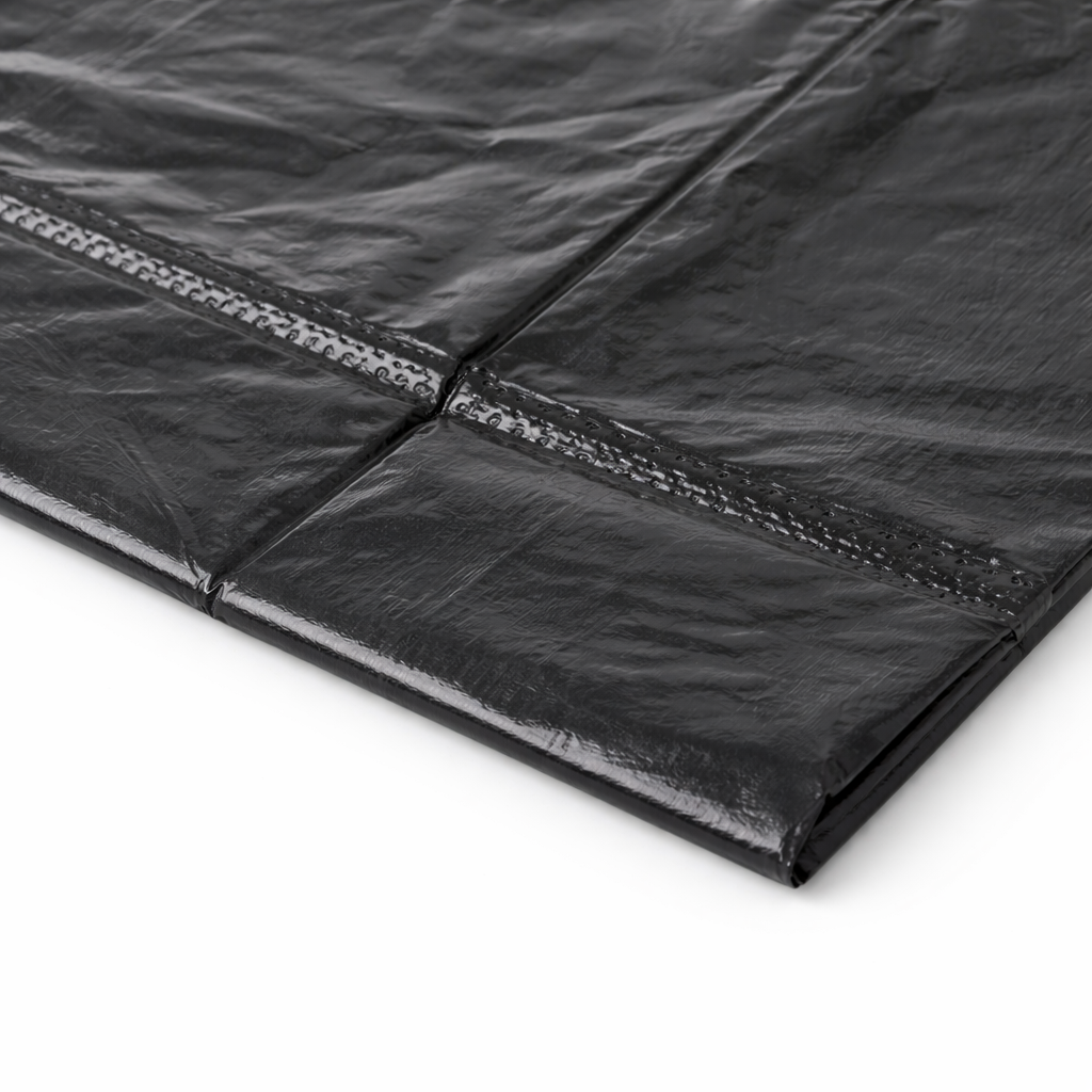 Close-up of a black garbage bag on a white background