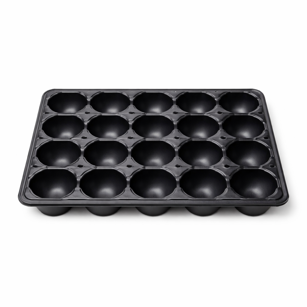 Black tomato-shaped mold tray on a white background